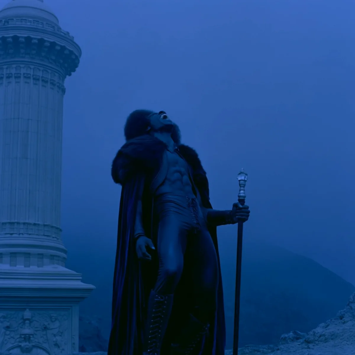 Dramatic caped figure beside a marble column at dusk, generated with Kling 3.0 Turbo